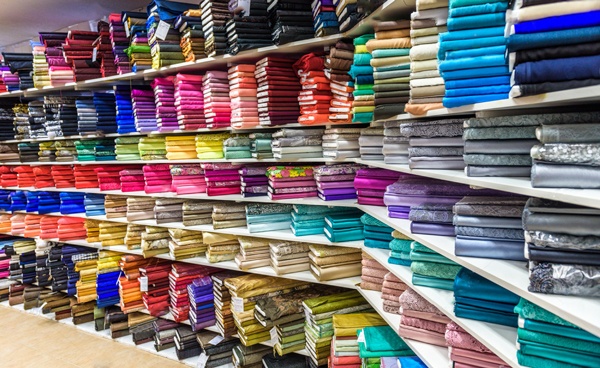 stock-photo-rolls-of-fabric-and-textiles-in-a-factory-shop-or-store-or-bazar-multi-different-colors-and-331556582