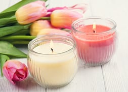 stock-photo-yellow-and-pink-aroma-candles-with-tulips-spa-composition-toned-vintage-602776505